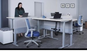 Office worker using a height-adjustable desk