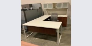 U-shaped white desk in an office space