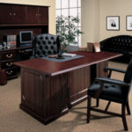 Dark brown desk with executive black chairs 